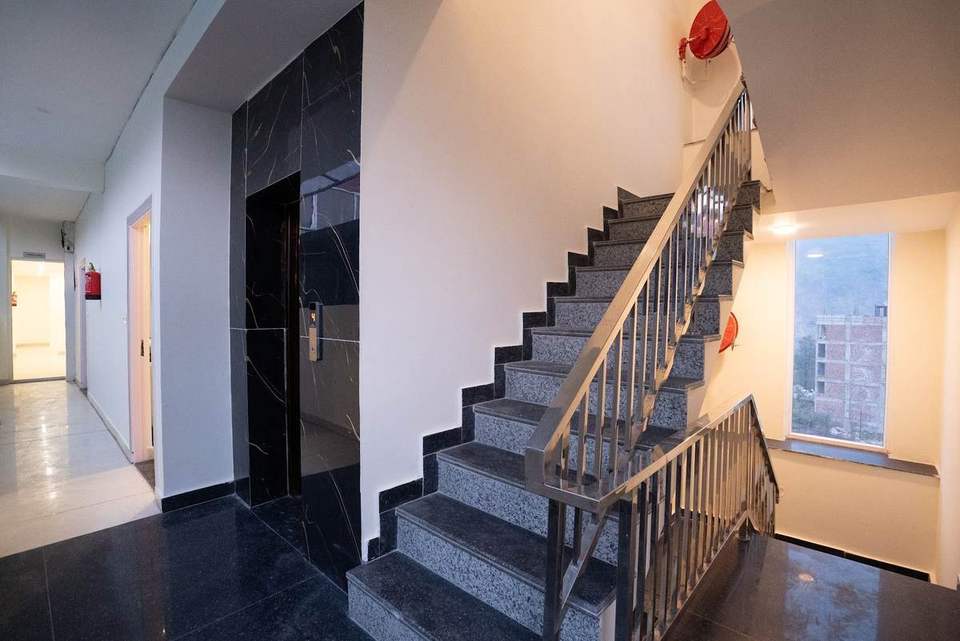 Black marble lift lobby and granite staircase at Alpine Retreat hotel, Tapovan, Rishikesh