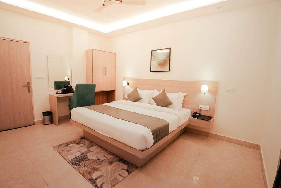 Standard Room with king bed, rug and desk chair at Alpine Retreat, 15 minutes from Laxman Jhula, Rishikesh