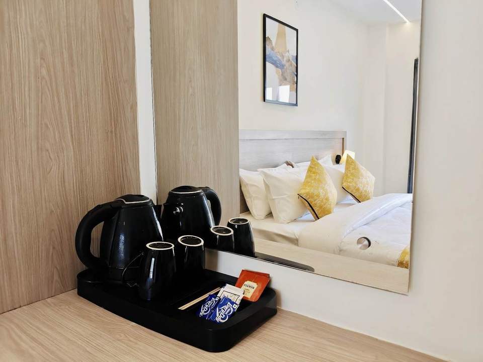 Electric kettle, cups and tea and coffee tray in a guest room at Alpine Retreat, Rishikesh